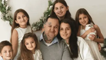 An emotional animated GIF transitioning between family photos of five children with their late father, Vladi, and a stylized illustration of a Phoenix bird rising, symbolizing rebirth and the new home provided by donors.